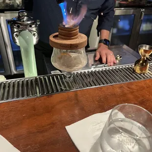 a bartender making a drink at a bar