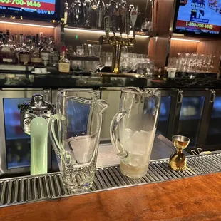 a bar with a lot of bottles and glasses