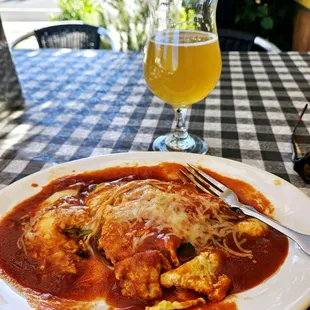 a plate of food and a glass of beer