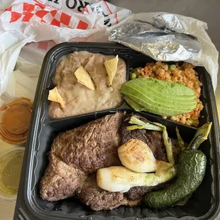 Carne asada, rice, beans, avocado, grilled Jalapeños, grilled green onion, tortilla, hot sauce