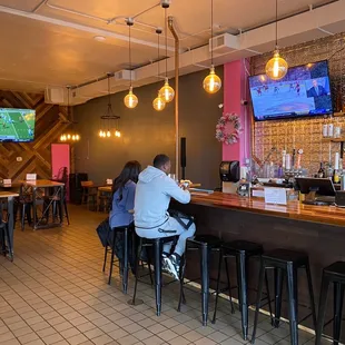 two people sitting at a bar