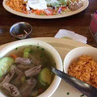 a bowl of soup and a plate of rice