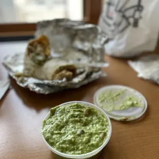 a bowl of guacamole and a plate of tortillas