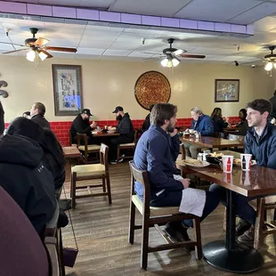 people sitting at tables in a restaurant