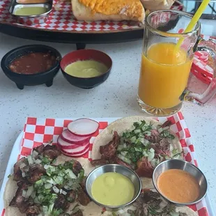 Burrito in the back. 3 tacos- Birria, tripas, asada