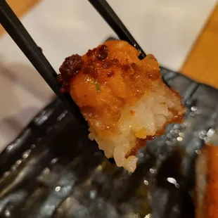 Close up of crispy rice topped with spicy salmon.