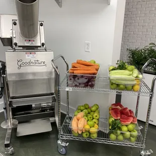 a commercial vegetable processor and a cart of vegetables