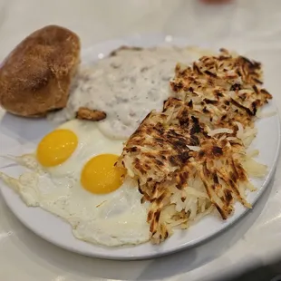 Country Fried Steak, sunny side up eggs, hashbrowns, and housemade biscuit