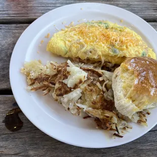 Western omelette with has browns and biscuit.