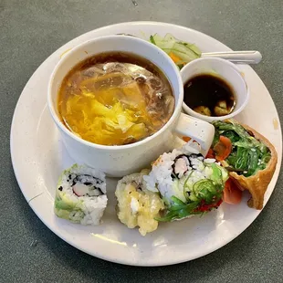 Combination of hot &amp; sour and egg drop soup with a squeeze of lemon plus sushi