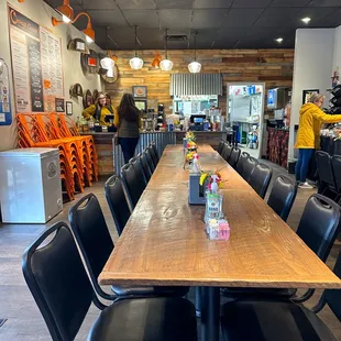 a long table with black chairs