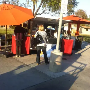 a woman standing in front of a booth