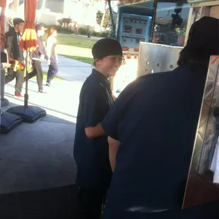 a man and a boy at a booth
