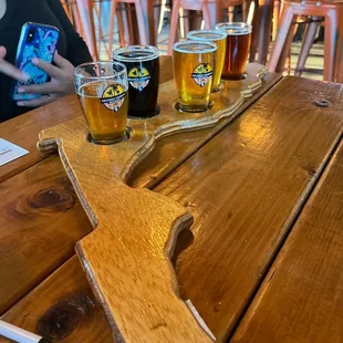 beer glasses and a wooden paddle on a table