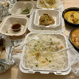 (Left to right) Garlic Naan, Rice 32oz, Chicken Samosa, Butter Chicken 16oz and Chicken Tikka Masala 16oz.