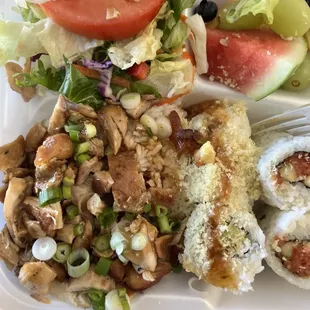 Teriyaki chicken, rice, sushi rolls, salad and fresh fruit