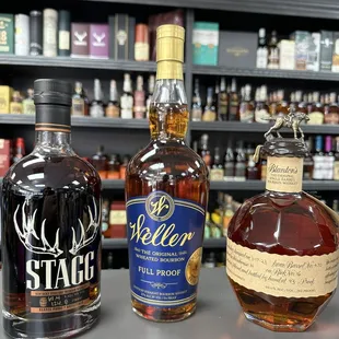 three bottles of whiskey on a counter