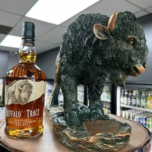 a buffalo statue and a bottle of buffalo trace