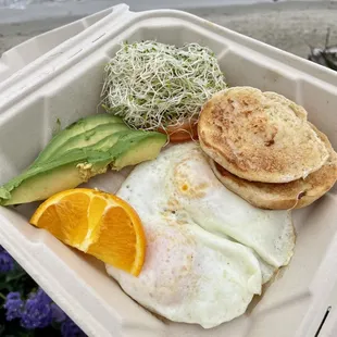 English muffin, eggs, avocado, tomato and sprouts