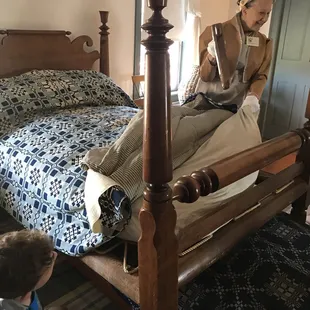 Showing us how the beds were put together.