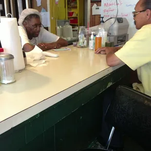 two men sitting at a counter