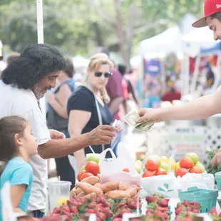  man handing money to a child