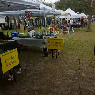 a group of people standing under tents