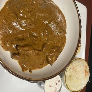 a bowl of curry and a bowl of coleslaw