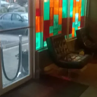 a chair in front of a stained glass window