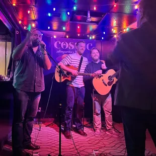 a group of people singing and playing instruments