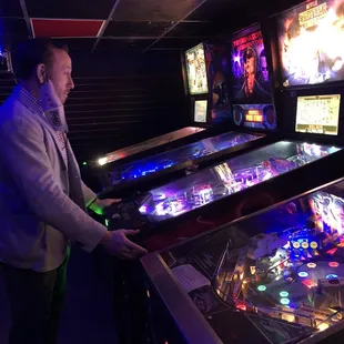 a man playing a game of pinball