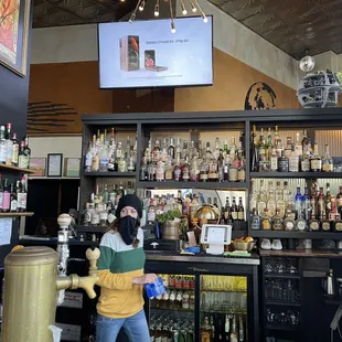 a woman standing at the bar
