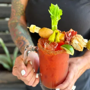 a woman holding a bloody drink