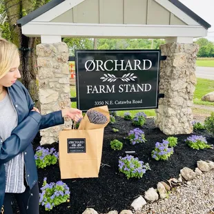 a woman standing in front of a sign