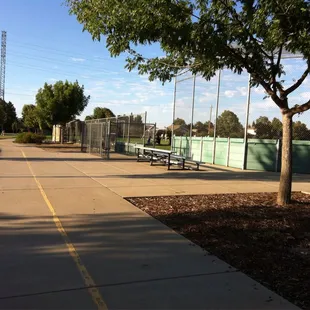 Bike trail going between the play structure and baseball/soccer fields.