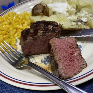 6 ounce filet cooked with potatoes and corn.