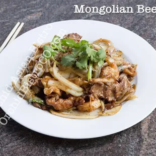 a plate of food with chopsticks