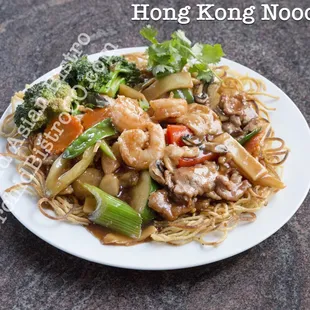 a plate of noodles with meat and vegetables