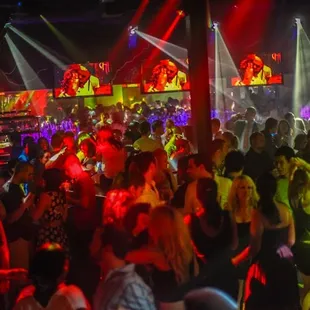 a crowd of people dancing at a nightclub