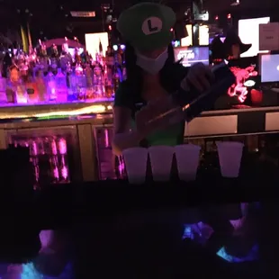 a bartender pouring a drink at a bar