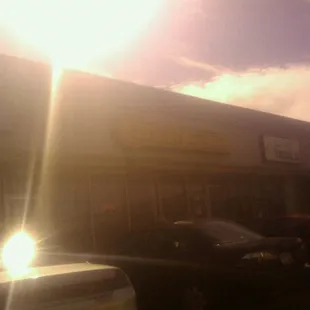 a parking lot with cars parked in front of it