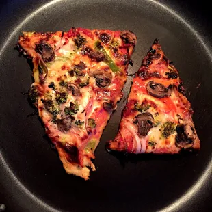 What two Veggie pizza slices look like AFTER you broil them and pan sear them at home. Total transformation!