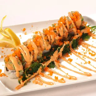 a plate of sushi with sauce drizzled over it