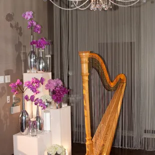 a harp and vases on a table