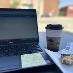 a cup of coffee next to a laptop