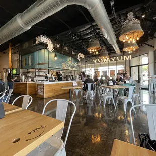 the interior of a restaurant with tables and chairs