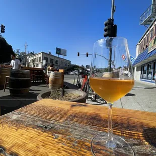 a glass of wine on a wooden table