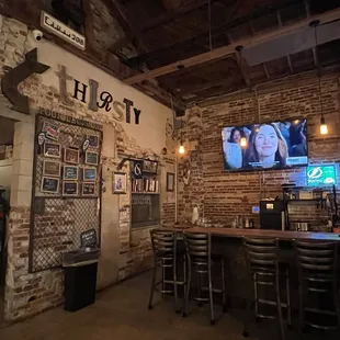 a bar with a television on the wall