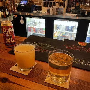 two glasses of beer on a bar