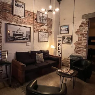 a living room with exposed brick walls